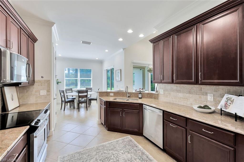 9058 Limestone Lane Naples, FL 34120 - Photo 11 of 48 a kitchen with lots of counter top space