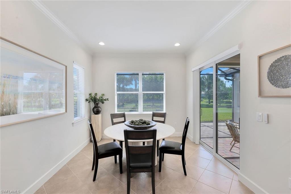 9058 Limestone Lane Naples, FL 34120 - Photo 12 of 48 a dining room with furniture and window