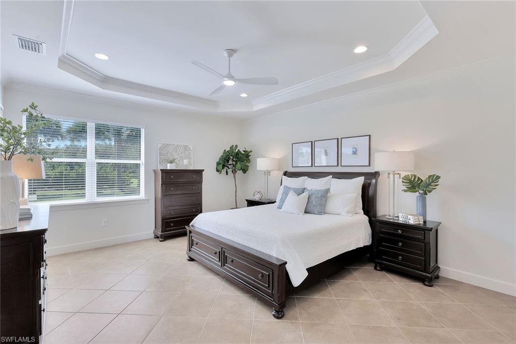 9058 Limestone Lane Naples, FL 34120 - Photo 14 of 48 a bedroom with a large bed and a window
