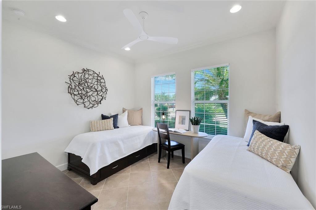 9058 Limestone Lane Naples, FL 34120 - Photo 18 of 48 a bedroom with a bed and a couch