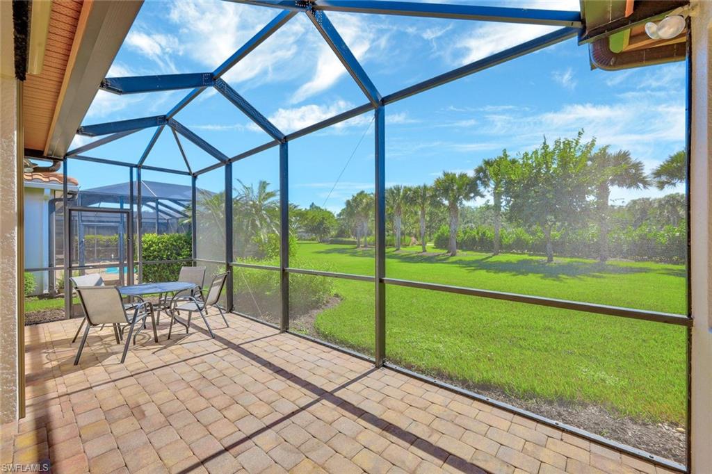 9058 Limestone Lane Naples, FL 34120 - Photo 22 of 48 a view of a porch with furniture and garden