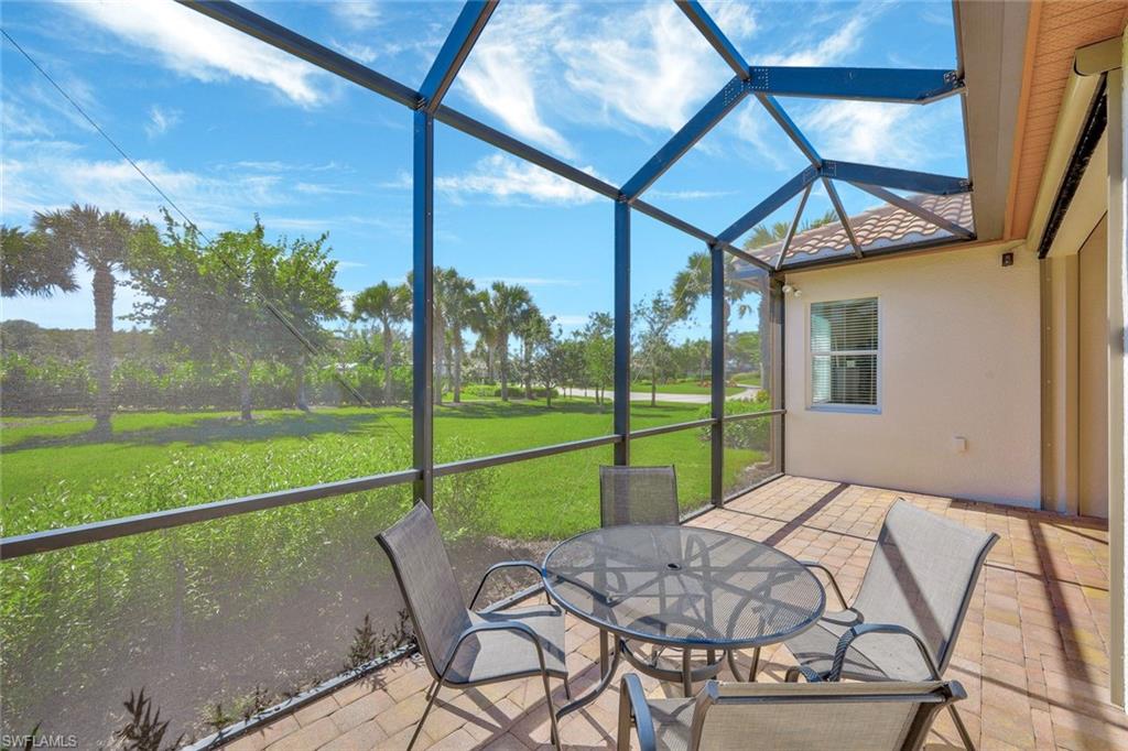 9058 Limestone Lane Naples, FL 34120 - Photo 23 of 48 a view of a deck with a table chairs and a backyard