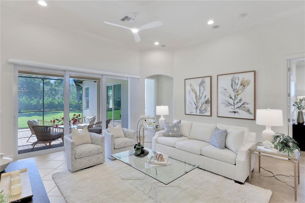 9058 Limestone Lane Naples, FL 34120 - Photo 4 of 48 a living room with furniture and a large window