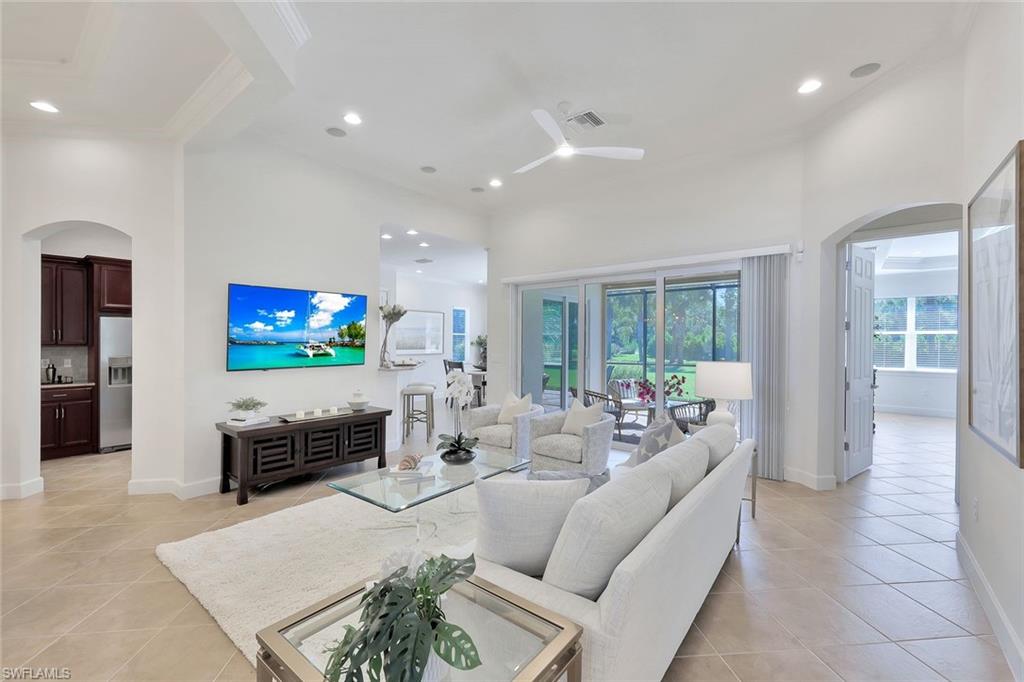 9058 Limestone Lane Naples, FL 34120 - Photo 5 of 48 a living room with furniture and a flat screen tv