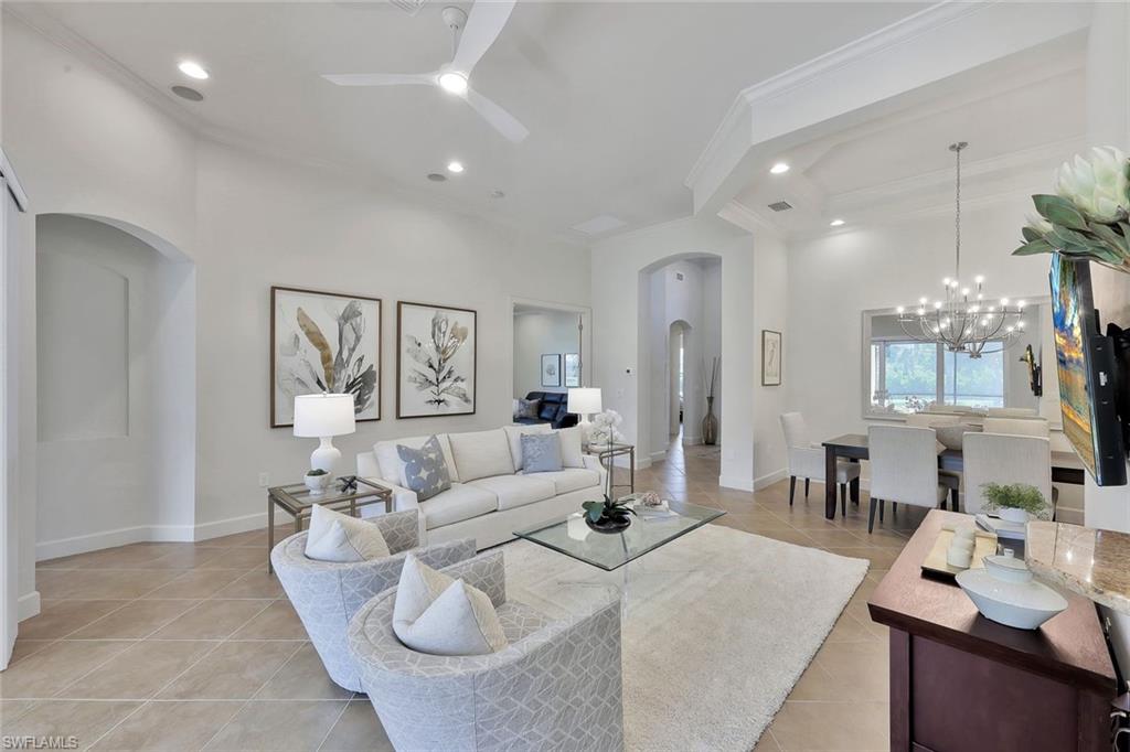 9058 Limestone Lane Naples, FL 34120 - Photo 6 of 48 a living room with furniture and a large window