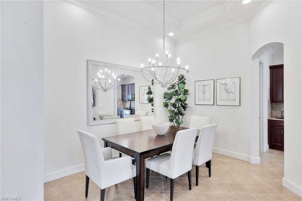 9058 Limestone Lane Naples, FL 34120 - Photo 7 of 48 a view of a dining room with furniture and chandelier