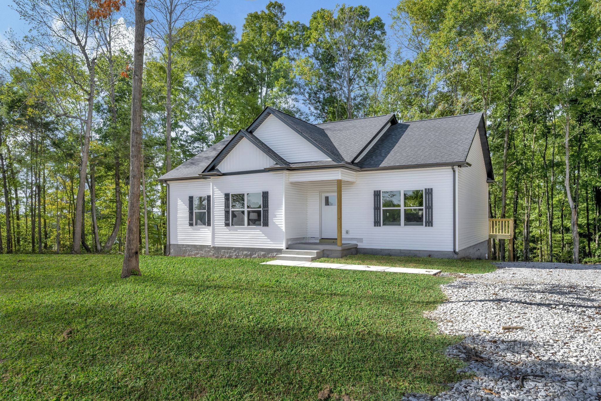 1514 East Piney Road Dickson, TN 37055 - Photo 26 of 29 a front view of a house with a garden and trees