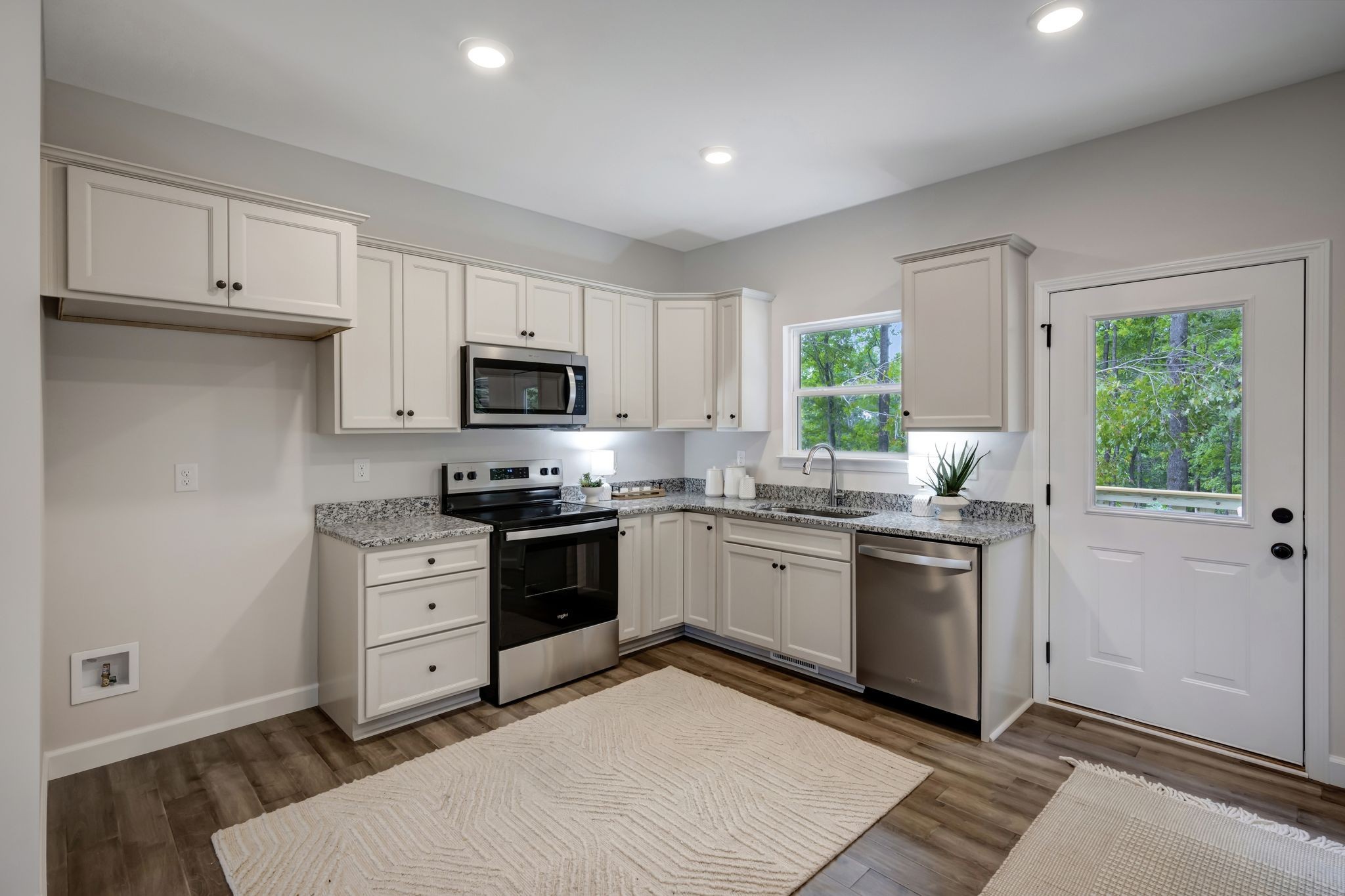 1514 East Piney Road Dickson, TN 37055 - Photo 7 of 29 a kitchen with granite countertop a stove a sink and a microwave