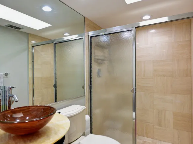 a bathroom with a sink toilet and shower