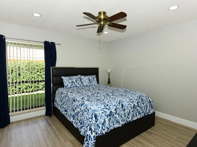 a bedroom with a bed and a large window