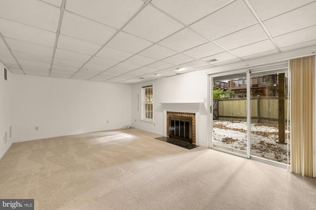 a view of an empty room with a fireplace