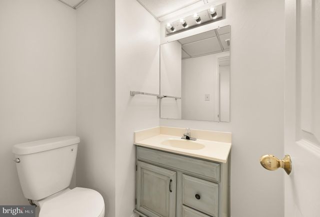 a bathroom with a sink a toilet and mirror