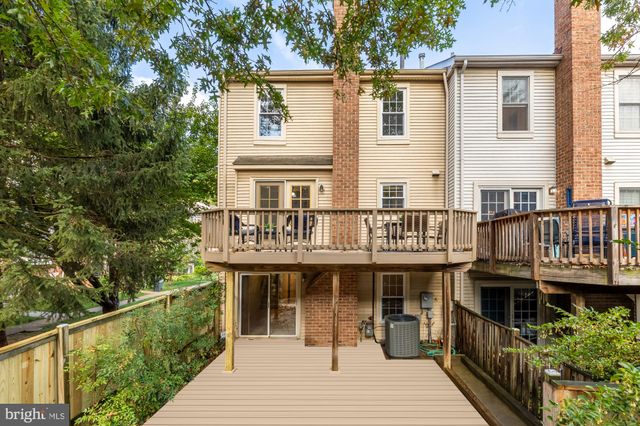 a view of a house with a deck and furniture