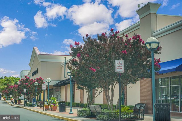 a front view of a house with a tree
