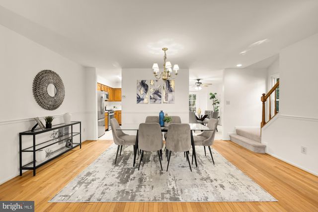 a view of a dining room with furniture and a chandelier