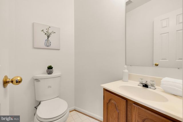 a bathroom with a sink vanity mirror and toilet