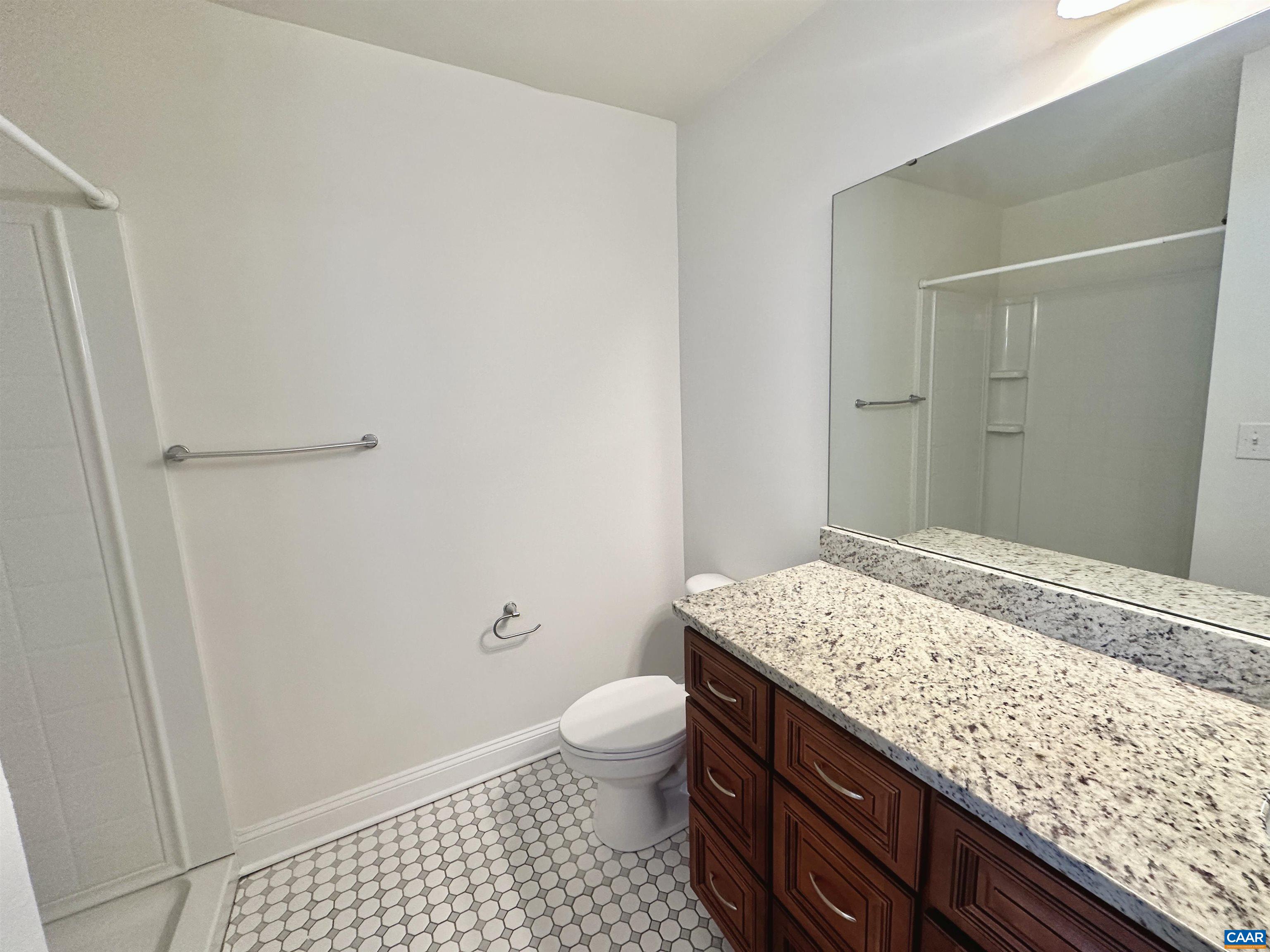 101 Turtle Creek Road, Unit 5 Charlottesville, VA 22901 - Photo 13 of 23 a bathroom with a granite countertop sink and a mirror