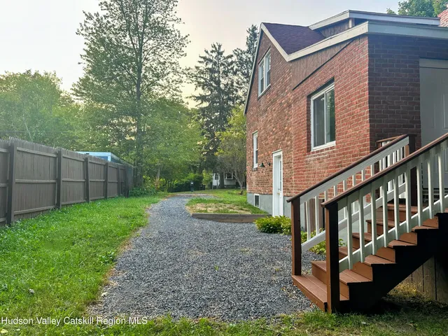 a view of a house with backyard porch and garden