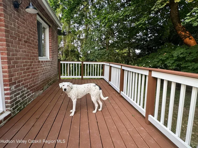a view of balcony with wooden floor and fence