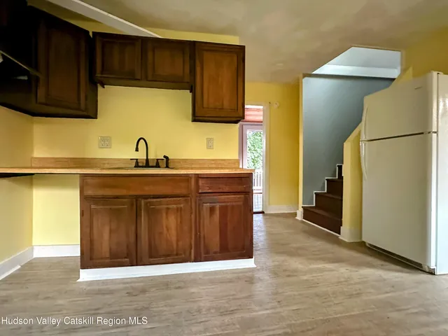 a kitchen with stainless steel appliances granite countertop a refrigerator and a sink