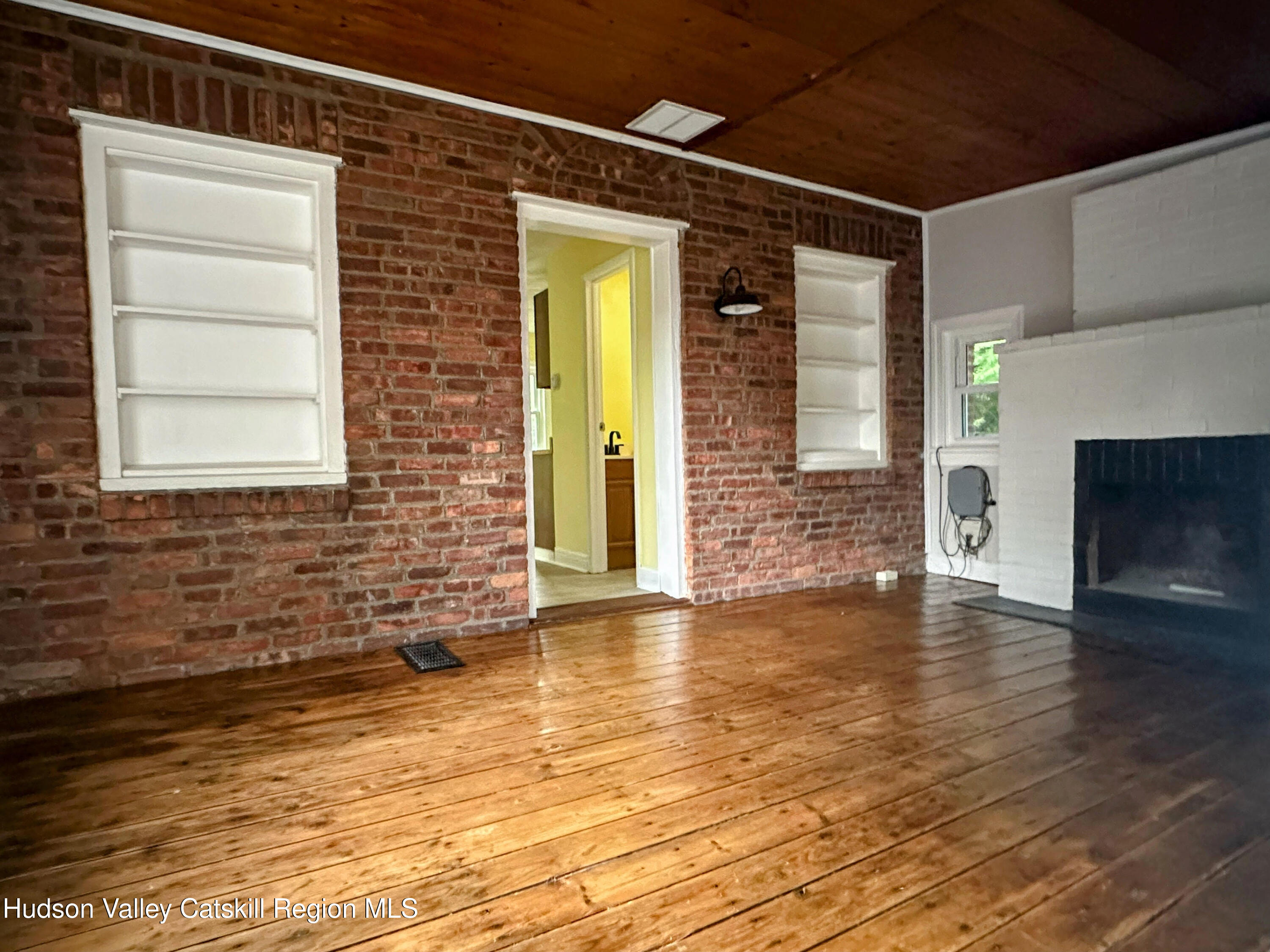 134 Lower Post Road Ghent, NY 12075 - Photo 5 of 19 a view of empty room with wooden floor and fireplace