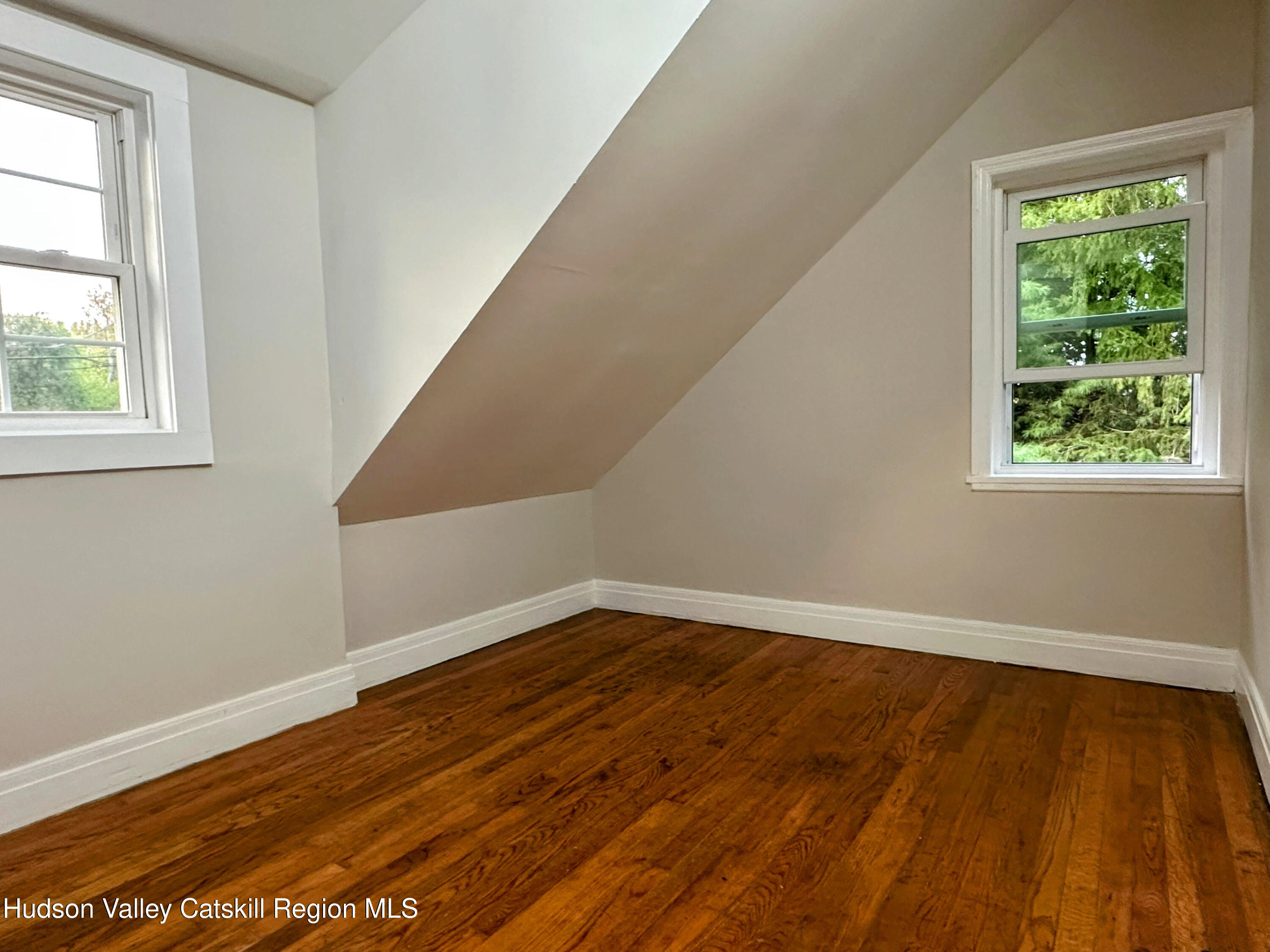 134 Lower Post Road Ghent, NY 12075 - Photo 10 of 19 a view of an empty room with wooden floor and a window