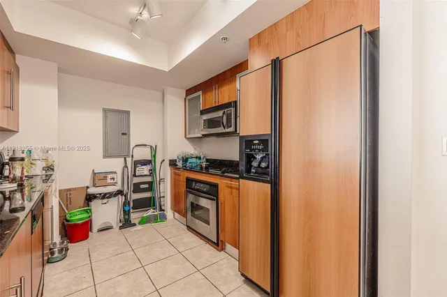 a kitchen with stainless steel appliances granite countertop a refrigerator and a stove