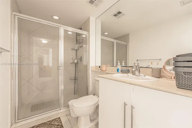 a bedroom with two beds and a desk