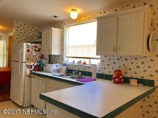 7268 Gas Line Road Keystone Heights, FL 32656 - Photo 4 of 12 a kitchen with stainless steel appliances a sink a refrigerator and a stove