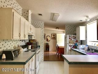 7268 Gas Line Road Keystone Heights, FL 32656 - Photo 5 of 12 a kitchen with kitchen island granite countertop a sink stove and cabinets