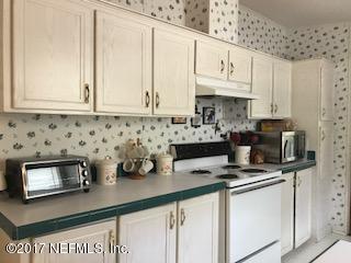 7268 Gas Line Road Keystone Heights, FL 32656 - Photo 6 of 12 a kitchen with stainless steel appliances granite countertop a sink a stove and a microwave