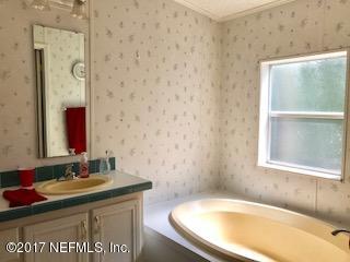 7268 Gas Line Road Keystone Heights, FL 32656 - Photo 10 of 12 a bathroom with a granite countertop sink and a bathtub
