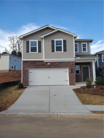 a front view of a house with garage
