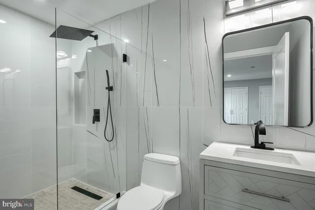 a bathroom with a bathtub shower sink and toilet