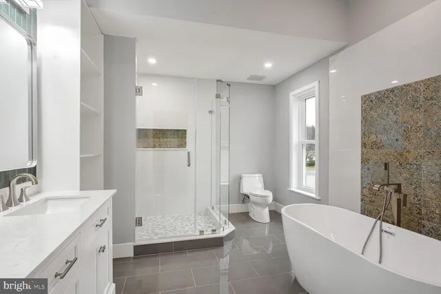a bathroom with a double vanity sink mirror and shower