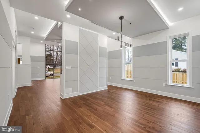 a kitchen with granite countertop white cabinets and stainless steel appliances