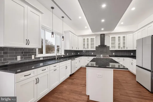 a kitchen with a sink stove and cabinets