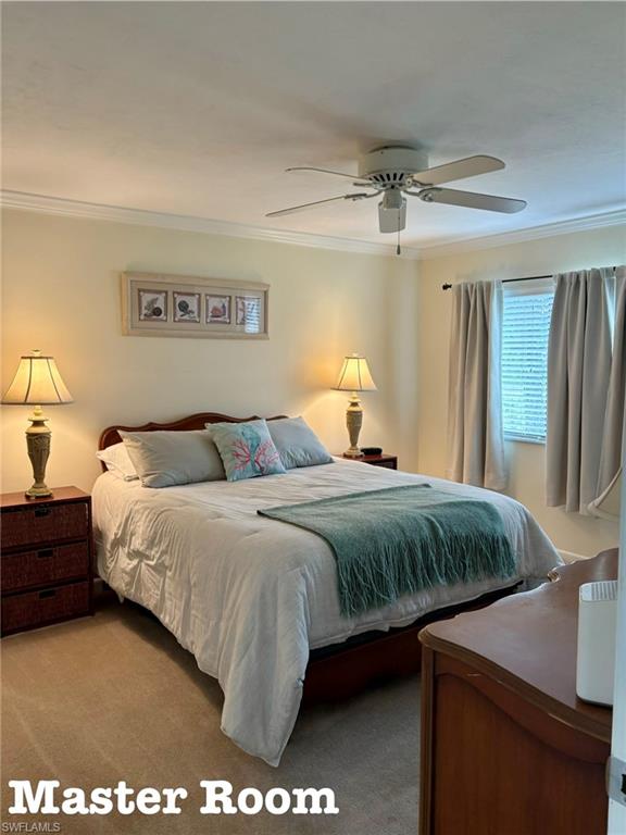 5841 Rattlesnake Hammock Road, Unit I203 Naples, FL 34113 - Photo 12 of 20 a bed sitting in a bedroom and chandelier