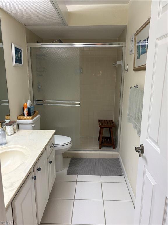 5841 Rattlesnake Hammock Road, Unit I203 Naples, FL 34113 - Photo 14 of 20 a bathroom with a sink a toilet and shower
