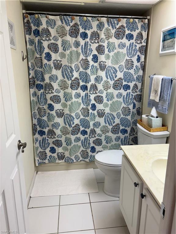 5841 Rattlesnake Hammock Road, Unit I203 Naples, FL 34113 - Photo 19 of 20 a bathroom with a sink and a toilet