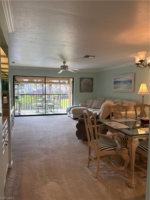 5841 Rattlesnake Hammock Road, Unit I203 Naples, FL 34113 - Photo 6 of 20 a living room with furniture and a flat screen tv