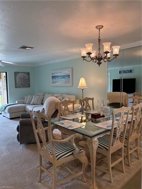 5841 Rattlesnake Hammock Road, Unit I203 Naples, FL 34113 - Photo 7 of 20 a dinning area with furniture kitchen view and a chandelier