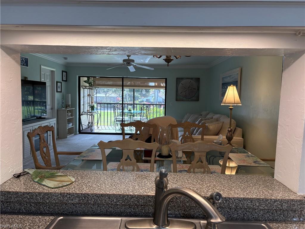 5841 Rattlesnake Hammock Road, Unit I203 Naples, FL 34113 - Photo 8 of 20 a living room with furniture and a window