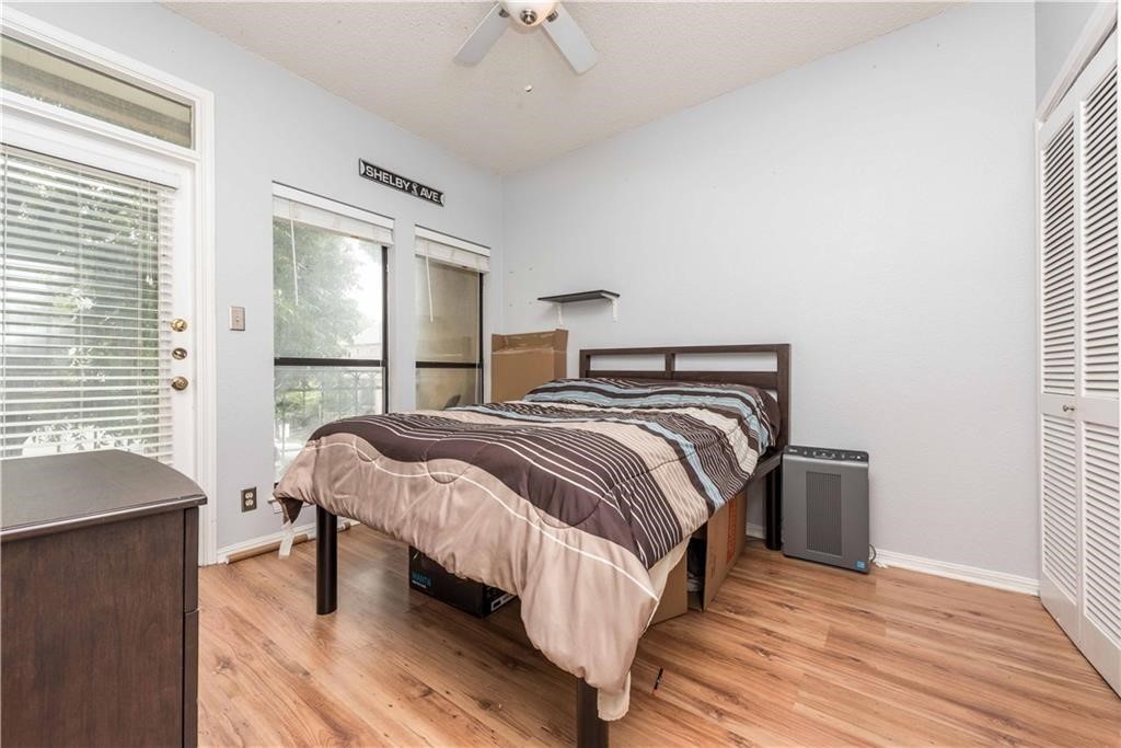 1910 Robbins Place, Unit 210 Austin, TX 78705 - Photo 12 of 13 a bedroom with a bed and a window