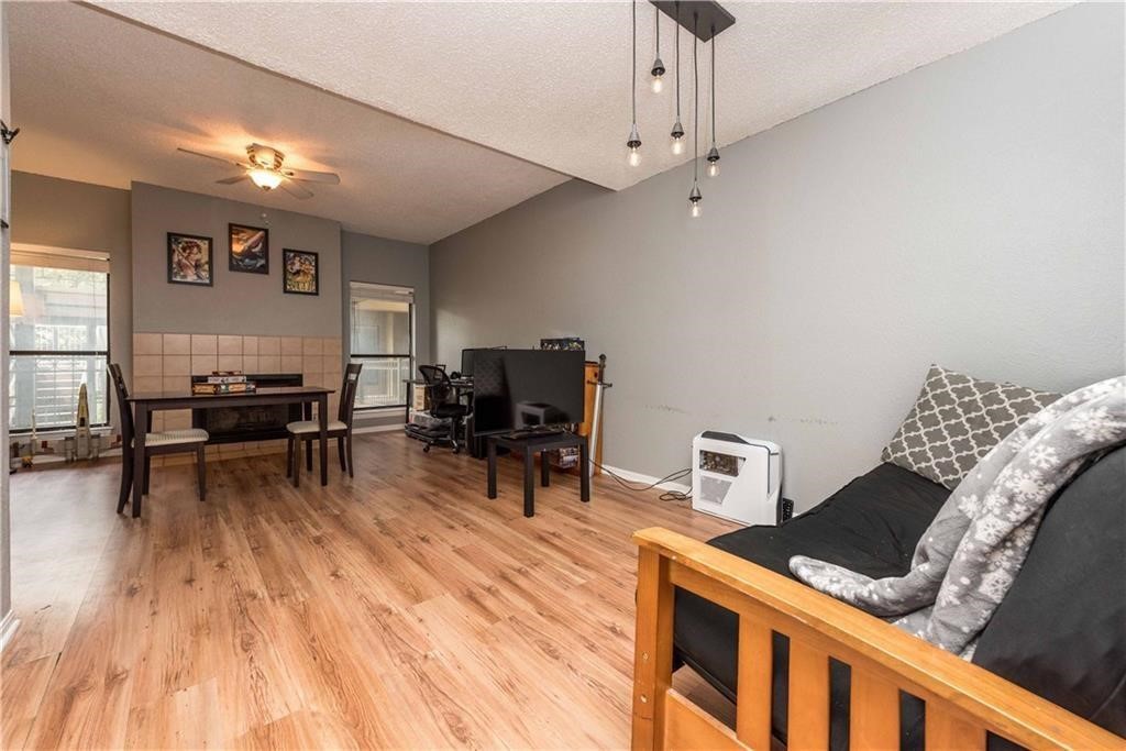 1910 Robbins Place, Unit 210 Austin, TX 78705 - Photo 4 of 13 a living room with furniture and a wooden floor