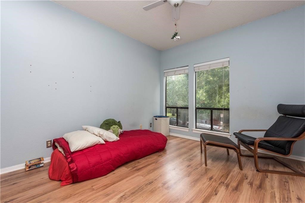1910 Robbins Place, Unit 210 Austin, TX 78705 - Photo 8 of 13 a living room with furniture and a wooden floor