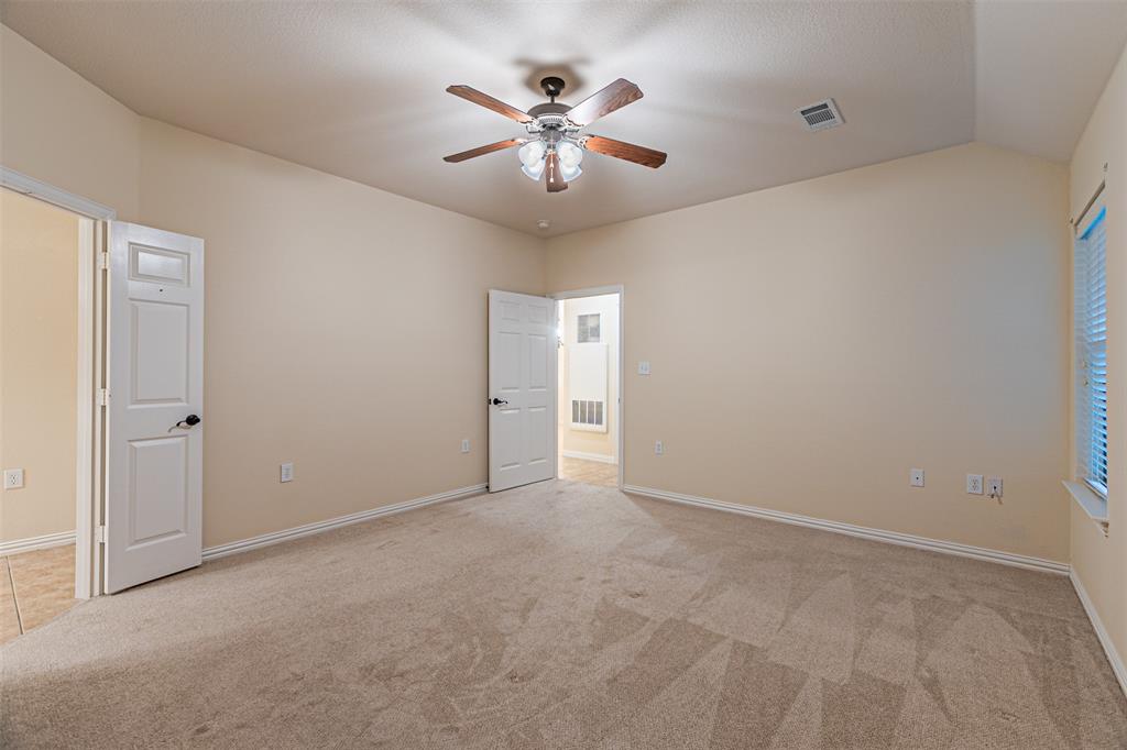 105 Sunglow Loop Red Oak, TX 75154 - Photo 22 of 40 a view of an empty room with a ceiling fan and a window