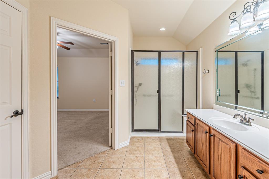 105 Sunglow Loop Red Oak, TX 75154 - Photo 24 of 40 a bathroom with a double vanity sink a mirror and a shower
