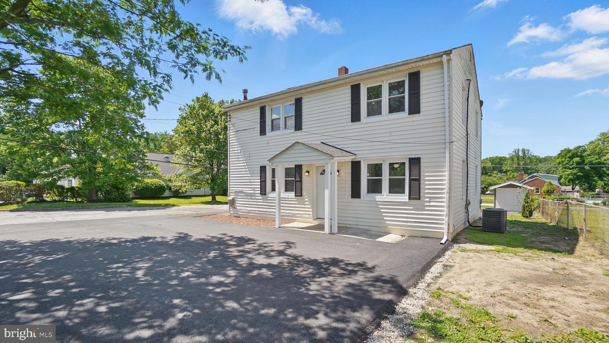 8014 Ritchie Highway Pasadena, MD 21122 - Photo 1 of 38 a front view of a house with a yard and garage