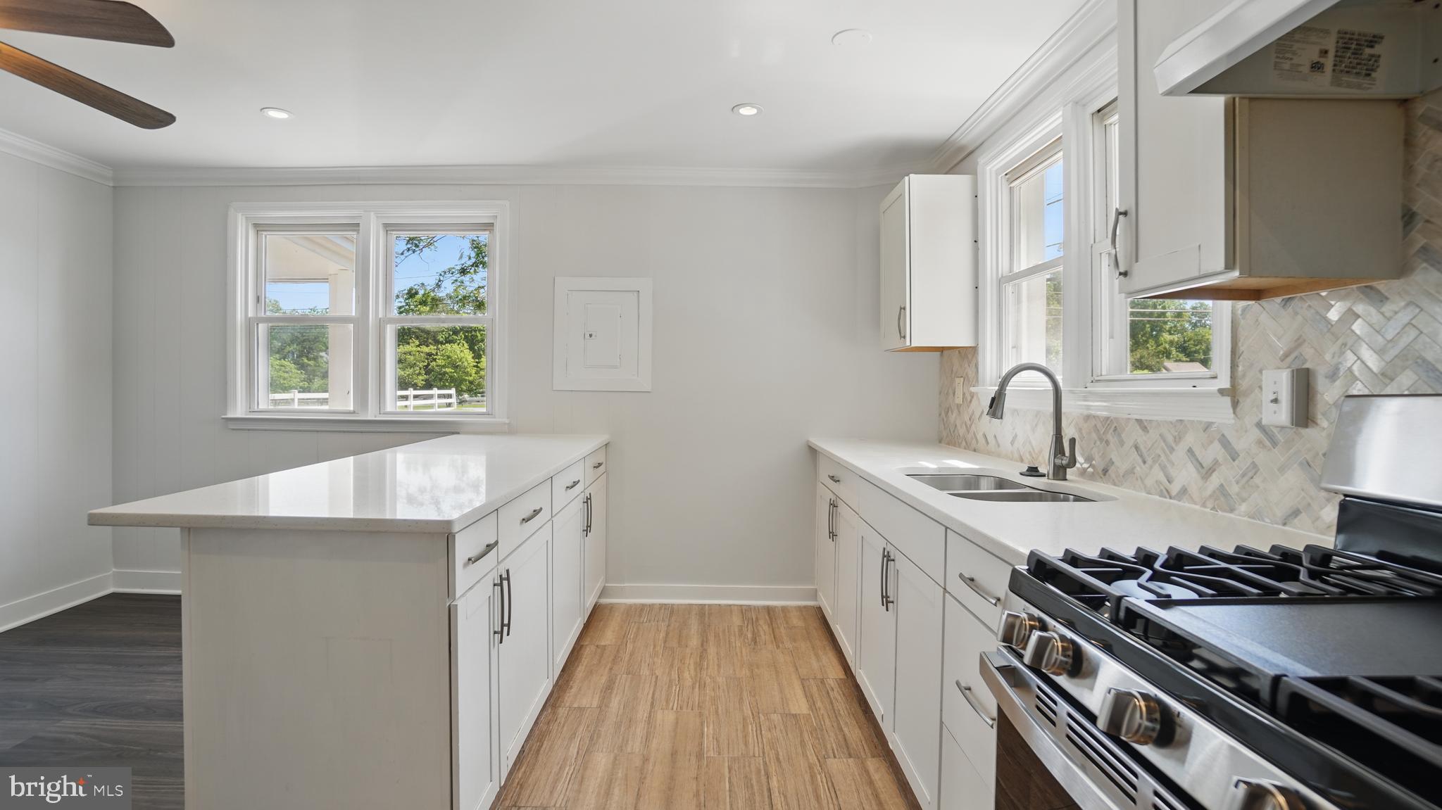 8014 Ritchie Highway Pasadena, MD 21122 - Photo 12 of 38 a kitchen with a sink stove top oven and cabinets